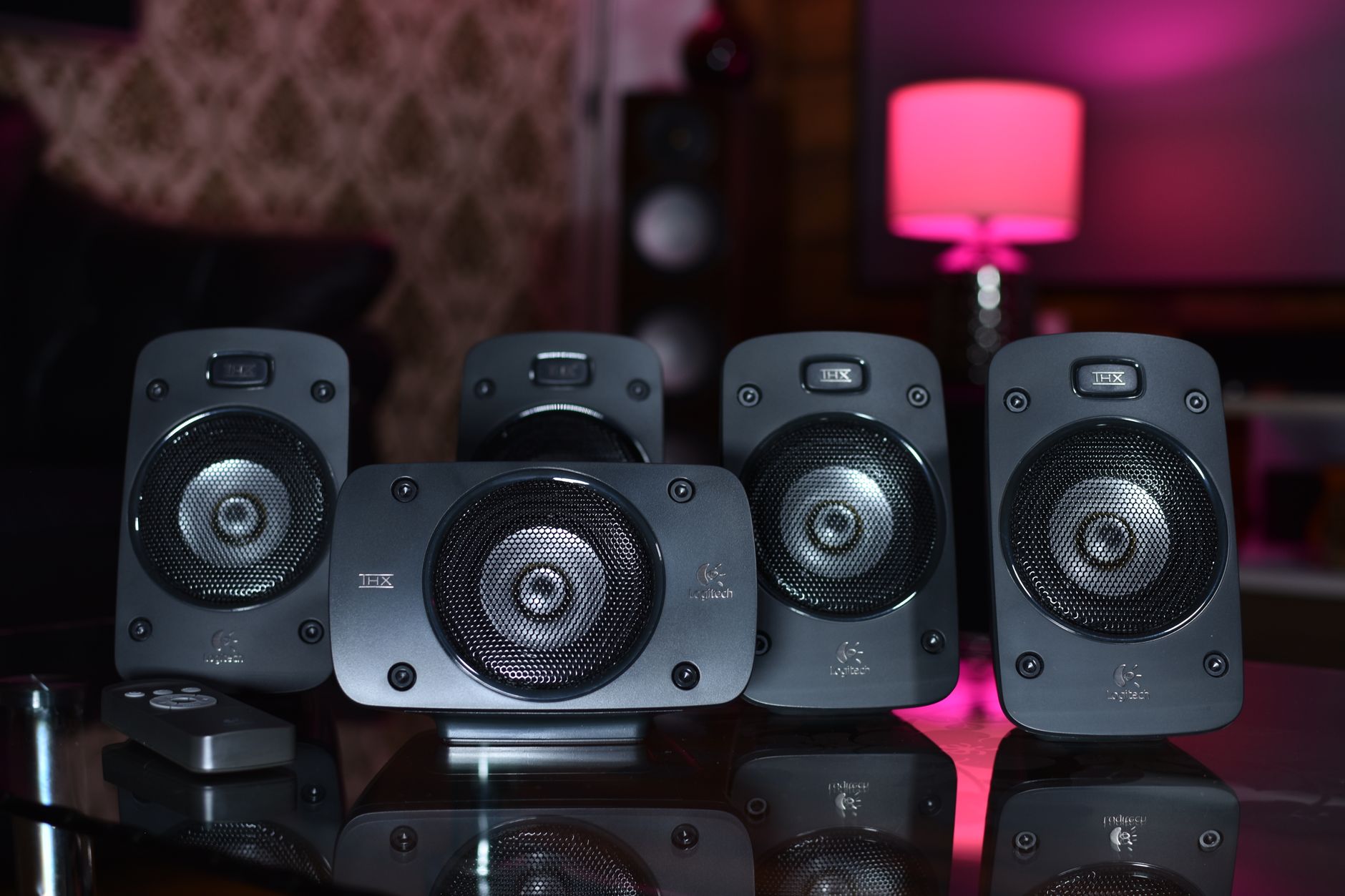 A close-up of a surround sound speaker system with remote, perfect for modern home entertainment.