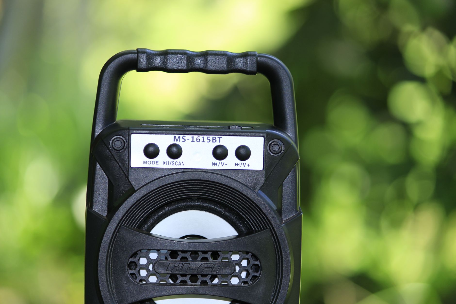 Close-up of portable Bluetooth speaker MS-1615BT in a vibrant outdoor setting.