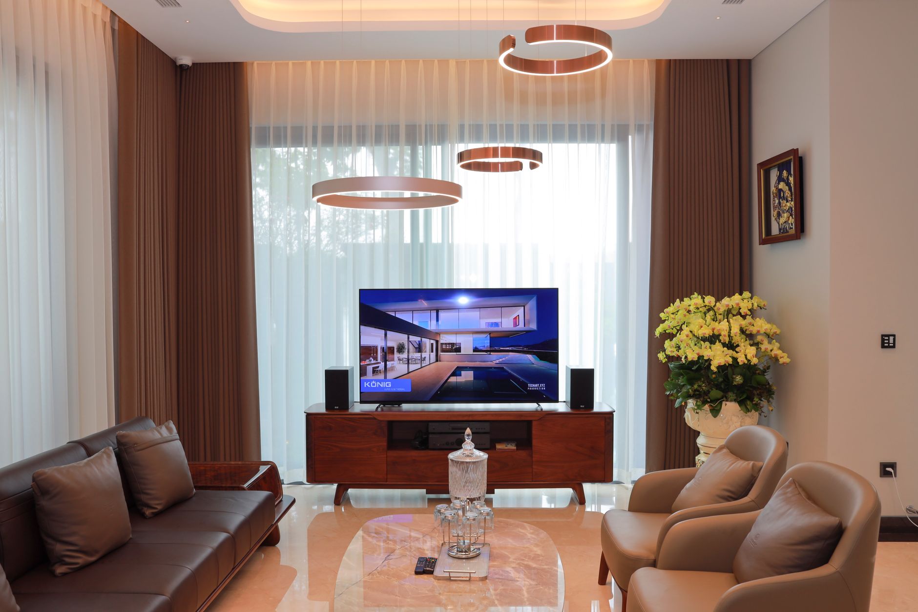 Elegant living room with modern decor, featuring a TV and stylish furniture.