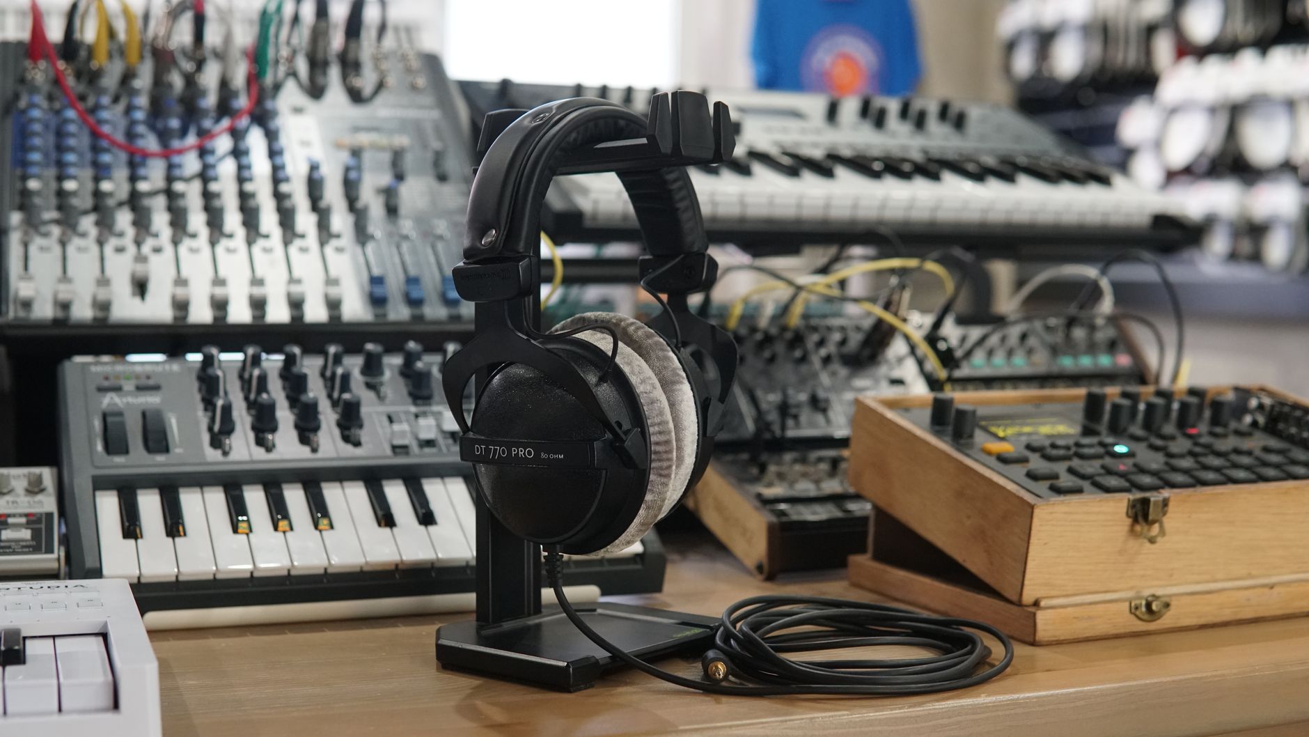 High-quality headphones and music production equipment in a modern studio setting.