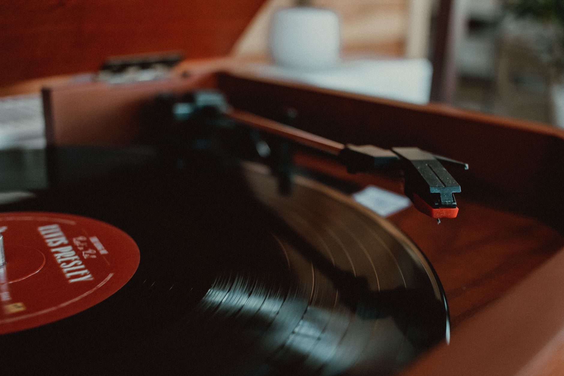 A close-up view of a vinyl record spinning on a classic turntable.