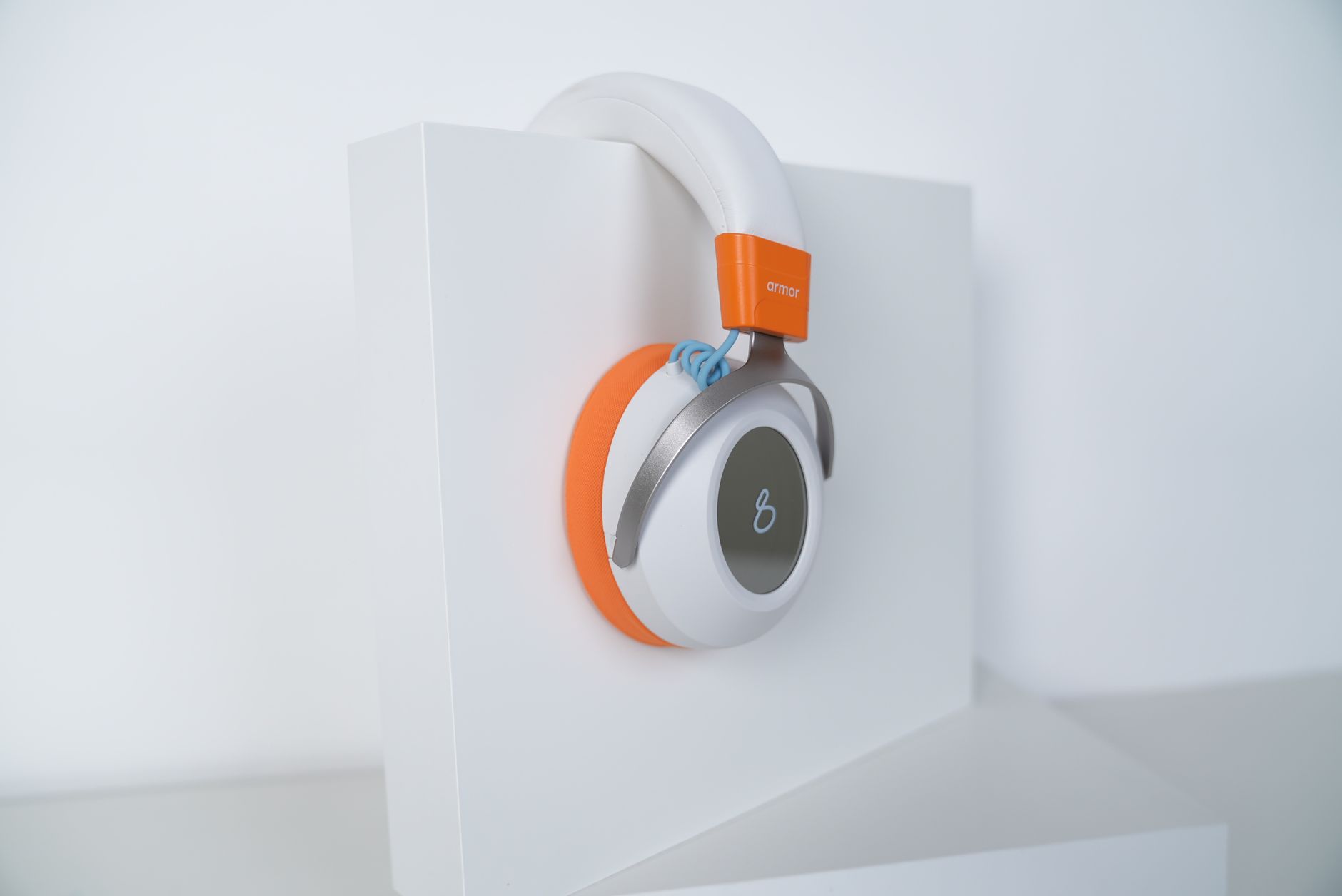 Stylish over-ear headphones with an orange accent, perfect for tech enthusiasts.