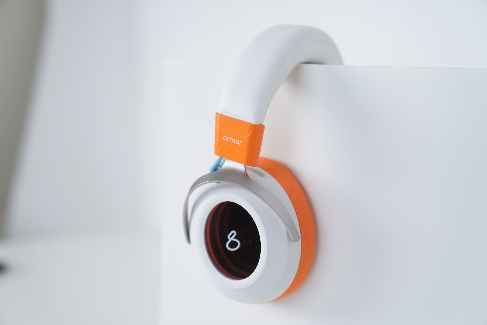 Sleek white and orange headphones with minimalist design, ideal for tech enthusiasts and modern aesthetics.