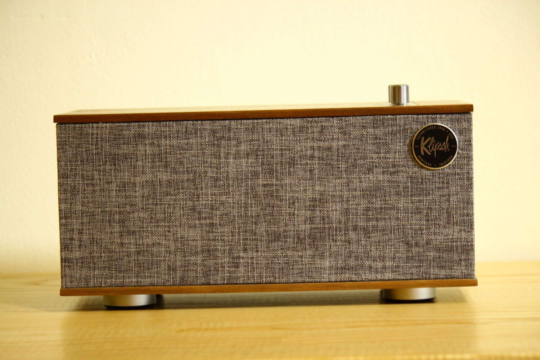 Stylish retro Bluetooth speaker on a wooden table, perfect for home decor.
