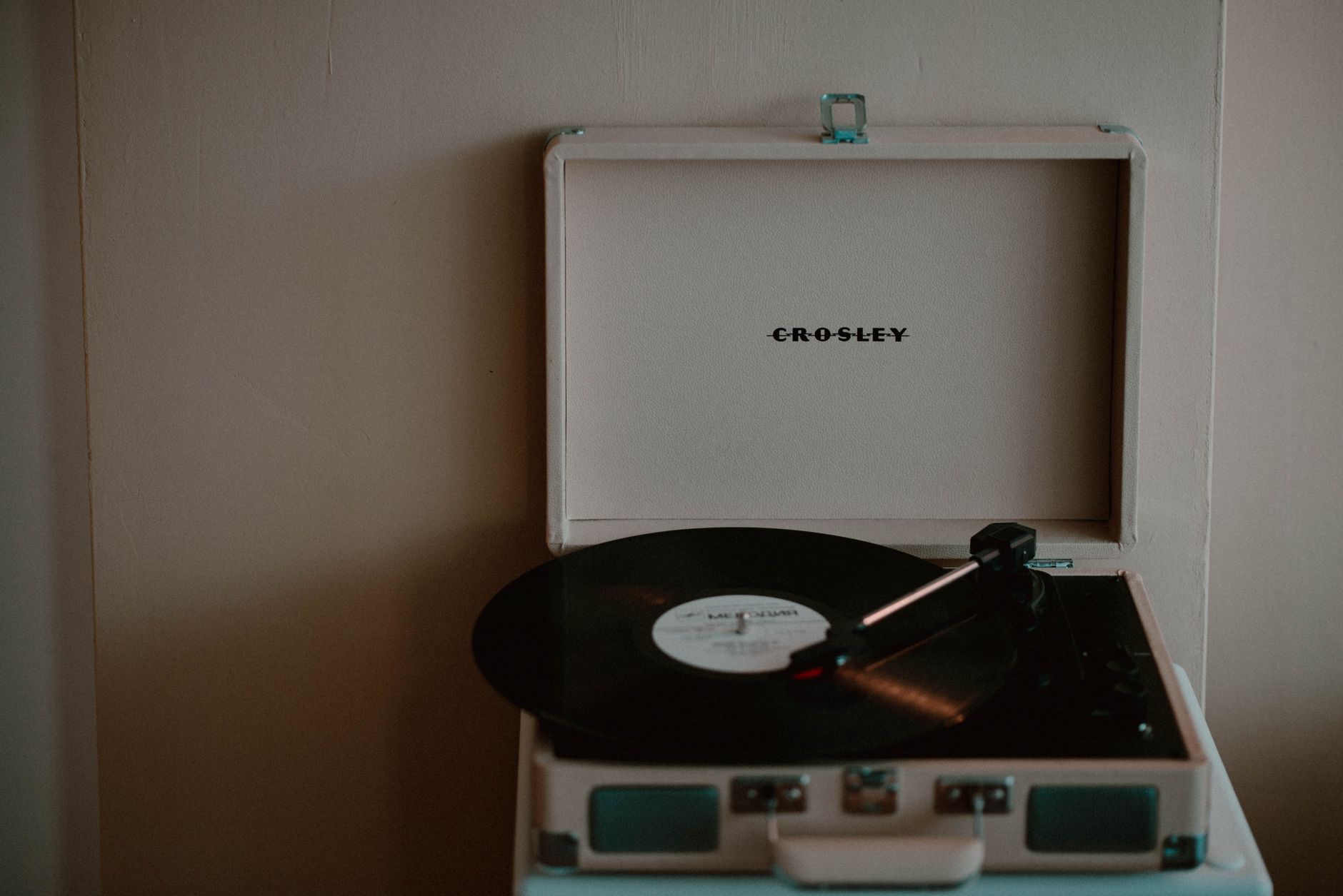 A nostalgic Crosley turntable with vinyl record creates a retro vibe.