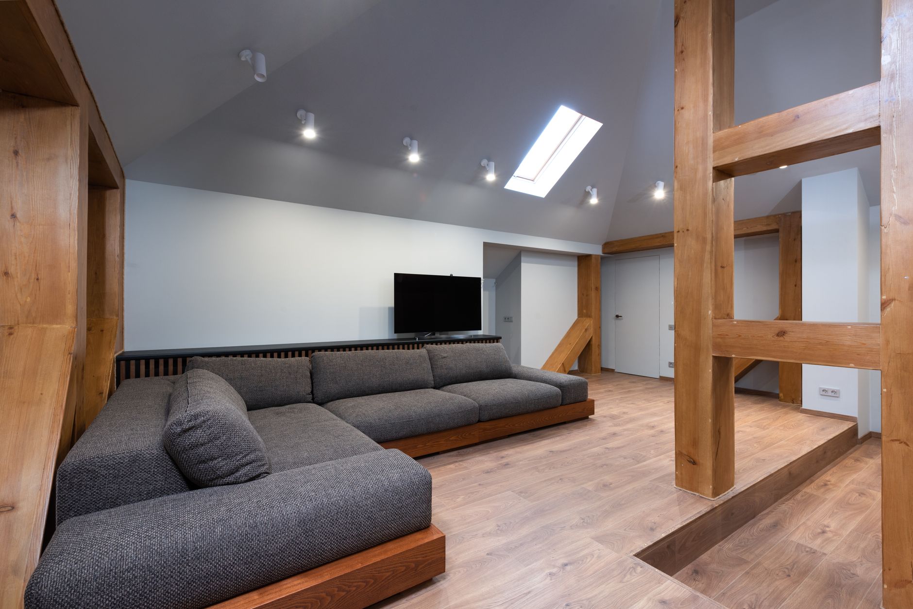 Interior of modern living room with TV and wooden construction in contemporary apartment