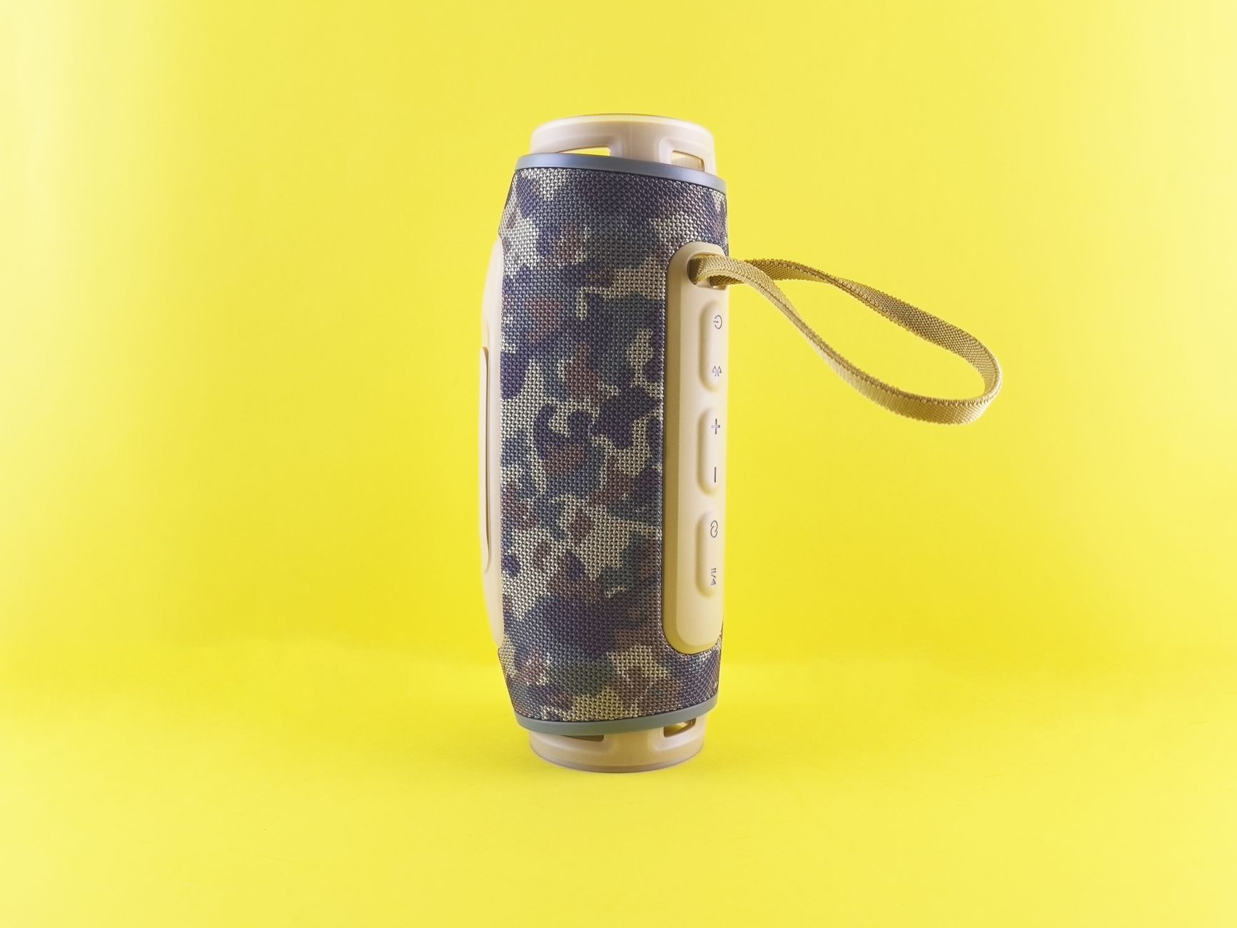 Compact Bluetooth speaker with camouflage pattern against a bright yellow background, ideal for outdoor use.