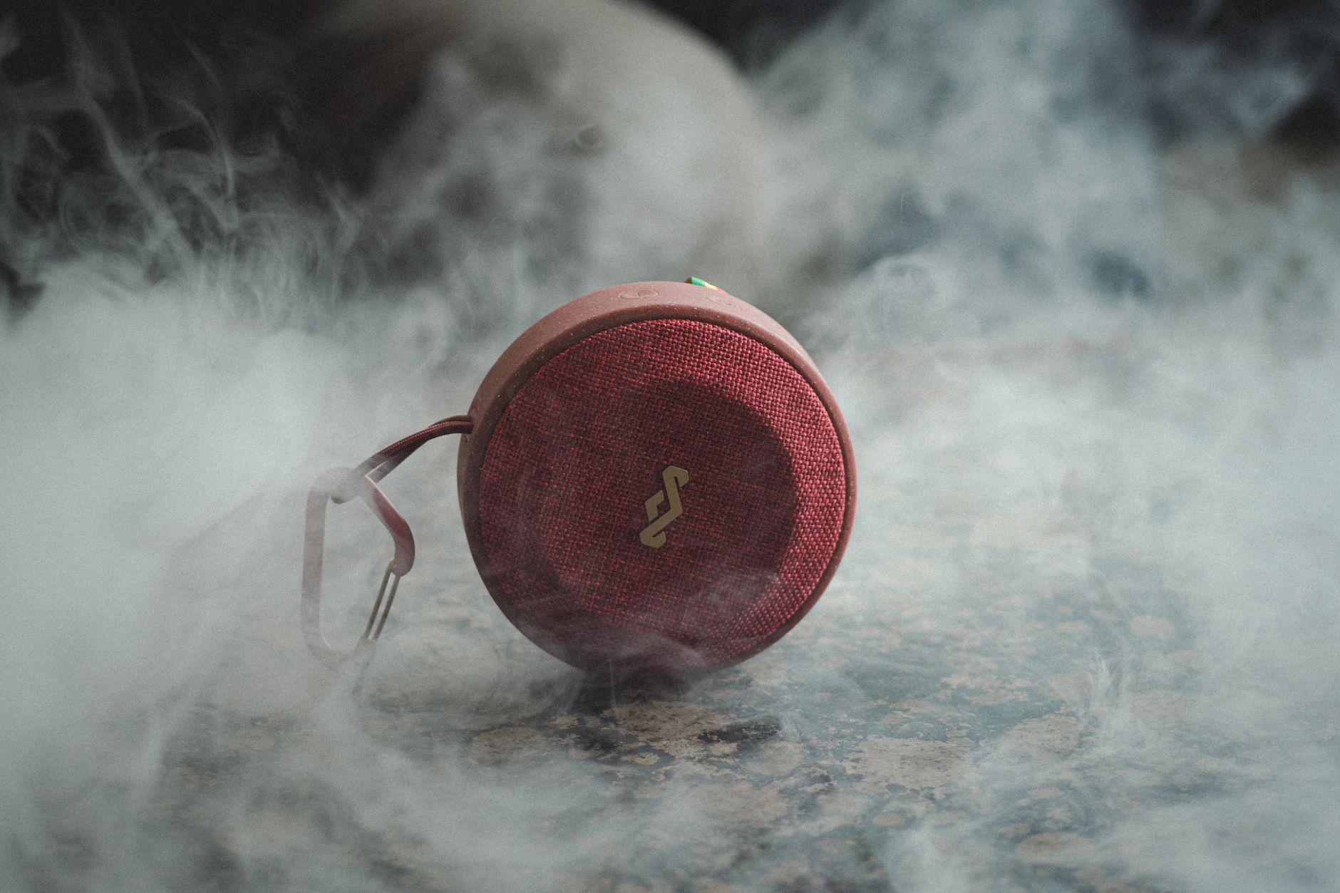 Red portable speaker surrounded by mysterious smoke in Beni M Tir, Tunisia.