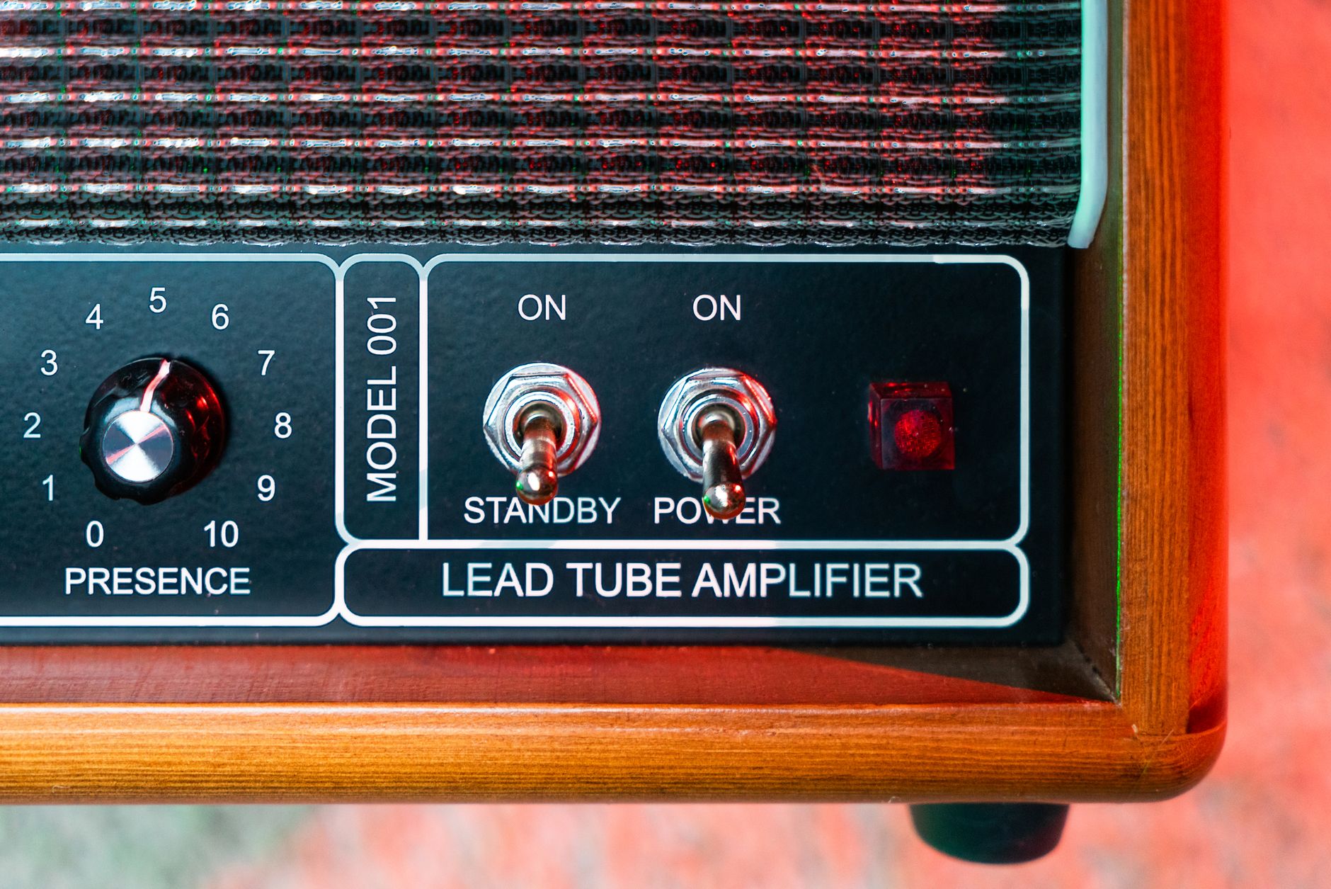 Detailed view of a vintage lead tube amplifier with control switches.